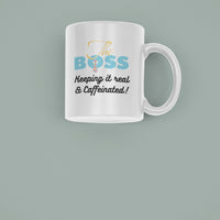 Stylish ceramic mug featuring 'The Boss - Keeping It Real & Caffeinated' in colorful text on a muted background.