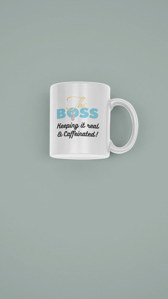 Stylish ceramic mug featuring 'The Boss - Keeping It Real & Caffeinated' in colorful text on a muted background.