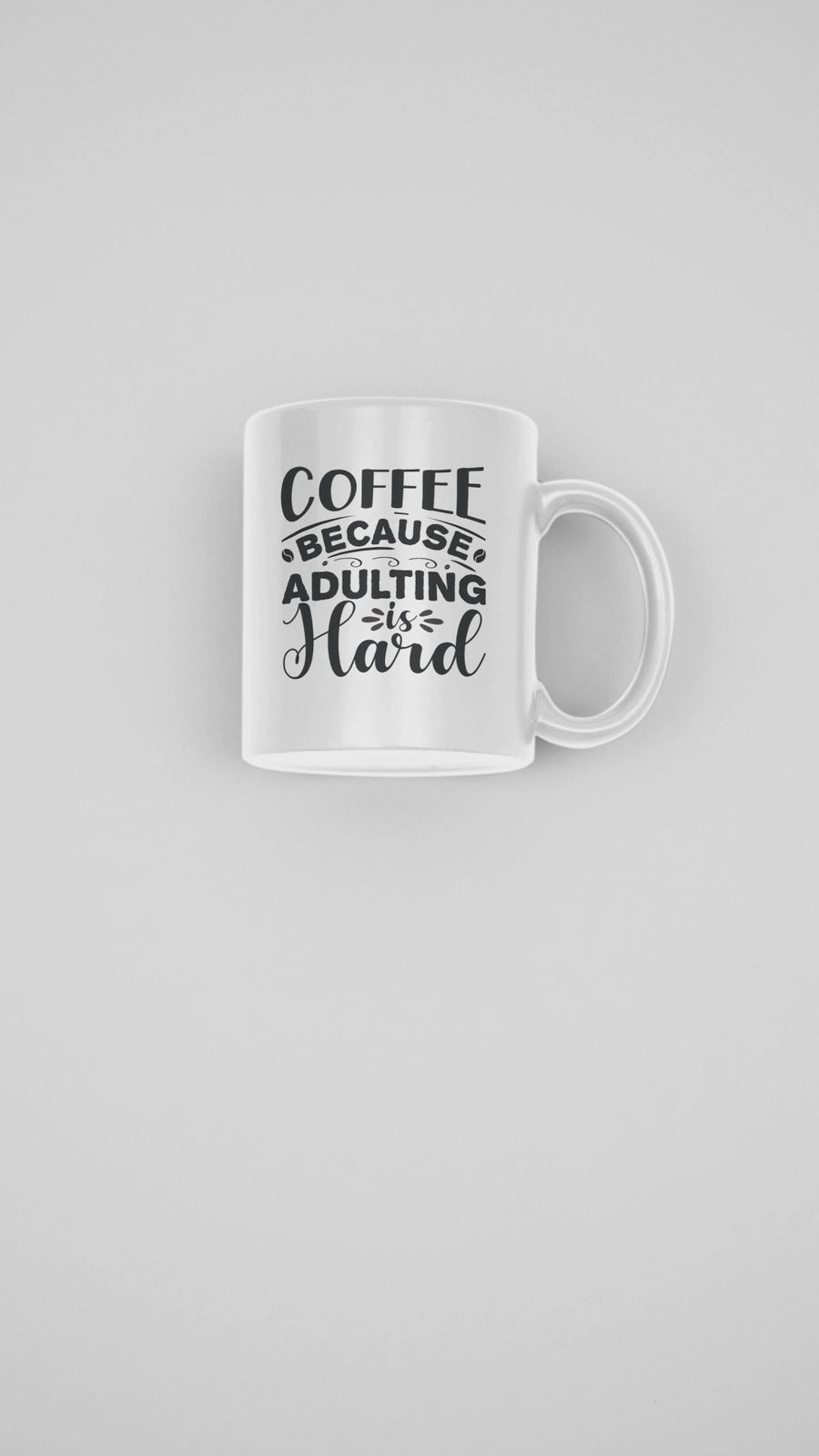 Funny coffee mug with bold black text saying 'Coffee Because Adulting is Hard', 11 oz ceramic cup for coffee lovers.