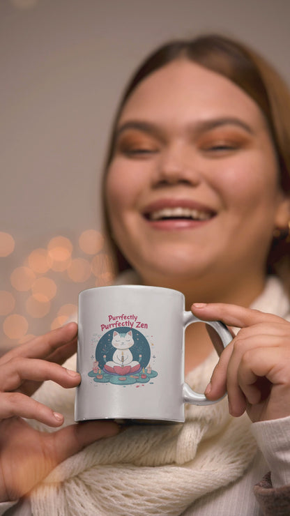 Smiling person holding a cute cat yoga mug that says 'Purrfectly Zen', ideal for cat lovers and coffee enthusiasts.